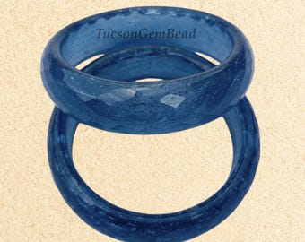 May include: Two blue resin rings with a textured surface. The rings are stacked on top of each other. The text "TucsonGemBead" is visible on the top ring.