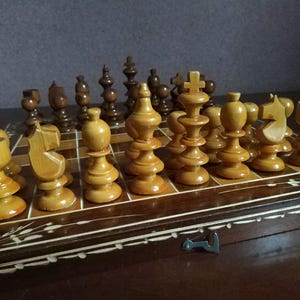 Wooden chess set complete with backgammon. You can also play checkers