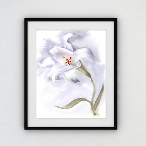 May include: Watercolor painting of a white lily flower with a yellow and red center, set against a soft, light purple background. The artwork is framed in a black frame, ready to hang. The botanical art print is a delicate and elegant piece.