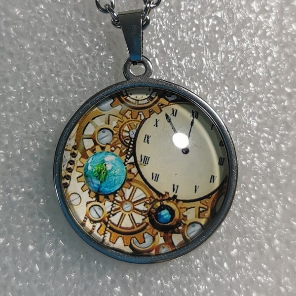 Collier avec pendant cabochon représentant des rouages et une horloge dans un style steampunk