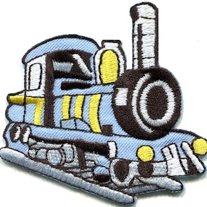 May include: An embroidered iron-on patch shaped like a steam locomotive train. The train is primarily light blue with dark brown outlines, yellow accents on the side and front, and a tall smokestack. The design features a circular front.