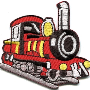 May include: An embroidered iron-on patch shaped like a steam locomotive train. The engine is primarily red with black, white, and yellow accents. It features a tall smokestack, a large front wheel, and yellow circular lights on the front.