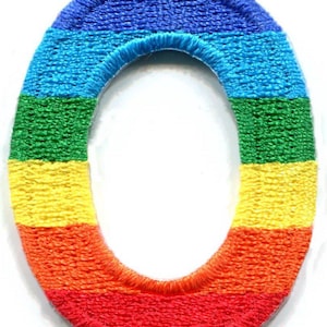 May include: An embroidered patch in the shape of the number zero, featuring horizontal stripes of blue, light blue, green, yellow, orange, and red thread with a thick, raised border and a textured finish throughout the entire surface.