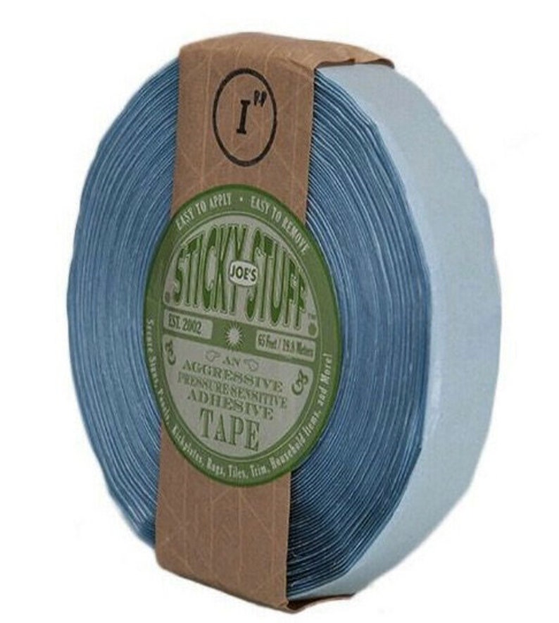 May include: A roll of blue 1-inch wide adhesive tape with a brown label that reads "Joe's Sticky Stuff" and "An Aggressive Pressure Sensitive Adhesive Tape".