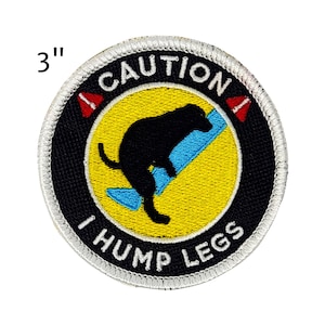 May include: Embroidered patch, 3 inches in diameter, with a black dog silhouette humping a blue object on a yellow background. The patch has a black border with the words "CAUTION" and "I HUMP LEGS".