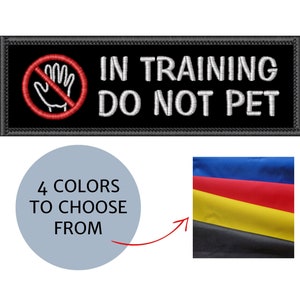 May include: Black embroidered patch with the text "IN TRAINING DO NOT PET" and a red hand symbol with a red circle and slash. The image also shows a color palette with four color options.