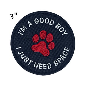 May include: A navy blue, 3-inch round embroidered patch with the text "I'M A GOOD BOY I JUST NEED SPACE" in white. A red paw print is in the center. Ideal for pet owners.