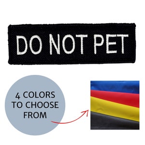 May include: A black rectangular patch with the words "DO NOT PET" embroidered in white. Below, a light blue circle states "4 COLORS TO CHOOSE FROM" with an arrow pointing to a swatch of blue, red, yellow, and black fabric.