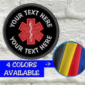 May include: A black embroidered patch with a red Star of Life emblem and white text that reads "YOUR TEXT HERE". A blue banner below states "4 COLORS AVAILABLE" with a color swatch of black, yellow, red, and blue.