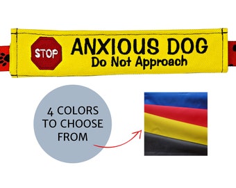 May include: Yellow fabric dog leash attachment with the text "ANXIOUS DOG Do Not Approach". Includes a red stop sign and paw print accents. The image also shows a color palette with four color options.