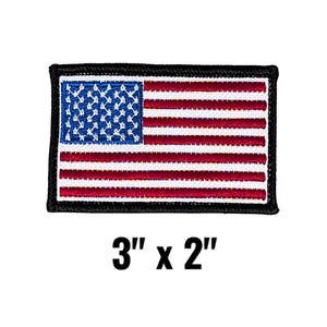 May include: A rectangular embroidered patch featuring the United States flag with red, white, and blue stitching, bordered by a thick black edge. The text 3" x 2" is printed below the patch, indicating its physical dimensions in inches.