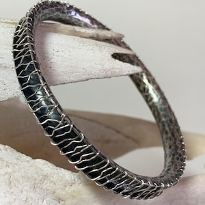 Contemporary bracelet, oxidized sterling silver bangle, hammered silver jewelry, artisan, avant garde jewelry, looks like sewn snake skin