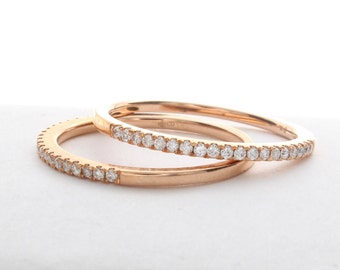 May include: Two thin gold bands with a row of small diamonds set in each band.