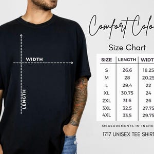 a man wearing a black t-shirt with a size chart and measurements in inches.