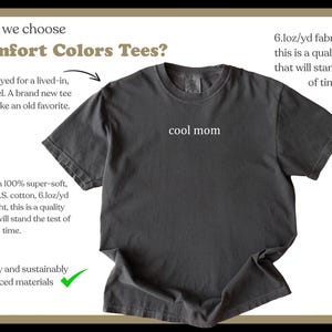 May include: A charcoal grey t-shirt with the text "cool mom" printed on the front. The shirt is made from a soft, comfortable fabric and is garment-dyed for a lived-in feel.