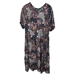 May include: A vintage midi dress with a patchwork pattern in shades of brown, black, and gray. The dress features short sleeves and a V-neckline. The fabric has a soft, flowing drape.