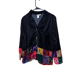 May include: Black velvet jacket with a patchwork hem. The jacket has a collared neckline and button closure. The patchwork features various colours and patterns, including red, green, and purple.