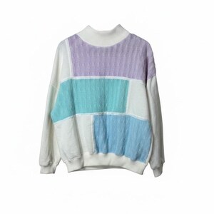 May include: A long-sleeve mock neck jumper featuring a colour-blocked design with white, lavender, teal, and light blue panels. The garment is constructed with a textured cable knit pattern on the coloured sections and solid white sleeves.