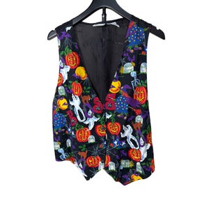 May include: Black Halloween vest with a colorful pattern of pumpkins, ghosts, bats, and spiders. The vest has a V-neck and is sleeveless. The lining is black. The vest is hanging on a black hanger.