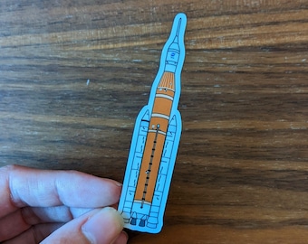 Sticker: NASA SLS Space Launch System for the Artemis Program - die cut vinyl sticker of hand drawn cartoon