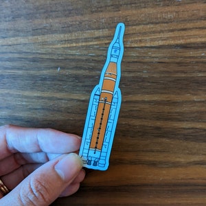 Sticker: NASA SLS Space Launch System for the Artemis Program - die cut vinyl sticker of hand drawn cartoon