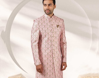 Puede incluir: Una kurta rosa de manga larga con un estampado floral y un cuello mandarín. La kurta se combina con pantalones de color crema.