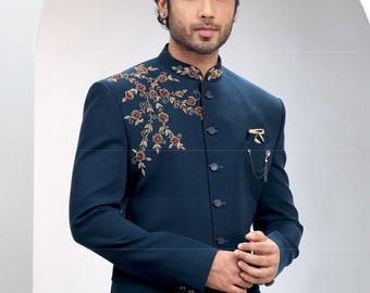 May include: A dark blue blazer with a mandarin collar and a floral embroidery design on the left shoulder. The blazer has a single button closure and multiple buttons down the front.