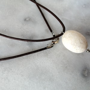 White egg-formed beach stone pendant, pebble necklace, beach stone necklace in dark brown leather cord