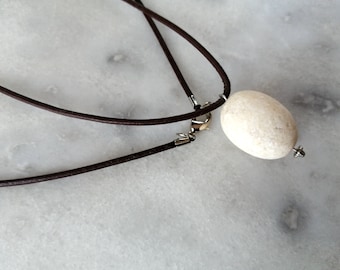 White egg-formed beach stone pendant, pebble necklace, beach stone necklace in dark brown leather cord