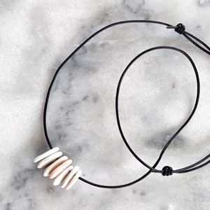 Seven beach stone necklace, beach pebble necklace, beach pebble pendant in an adjustable black leather cord