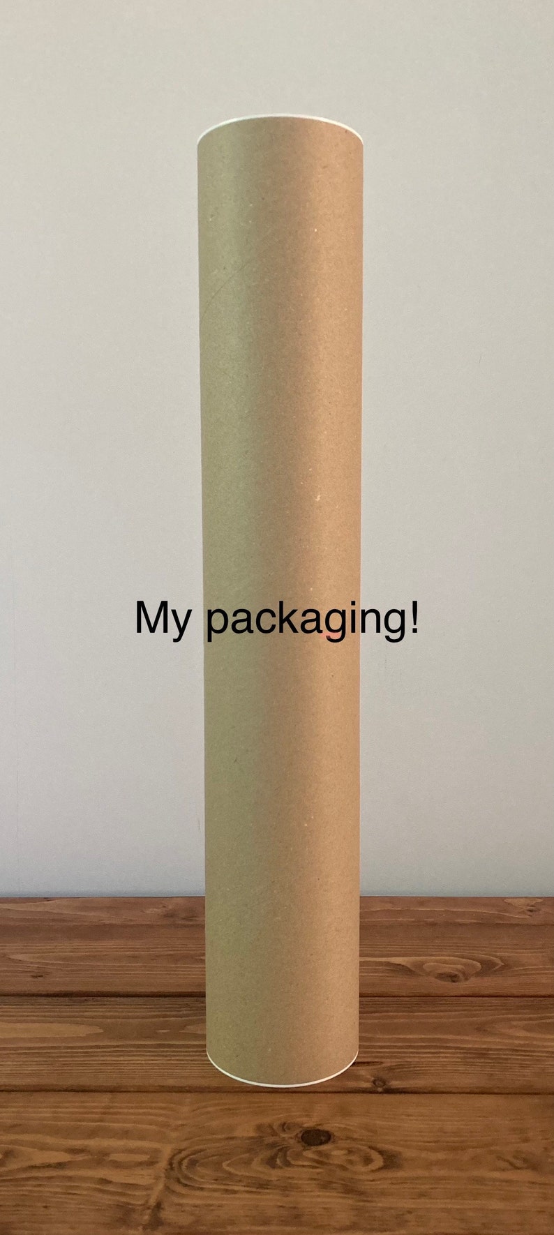 May include: A brown cardboard tube for shipping or storing rolled items. The tube has a white label with the text "My packaging!" printed on it.