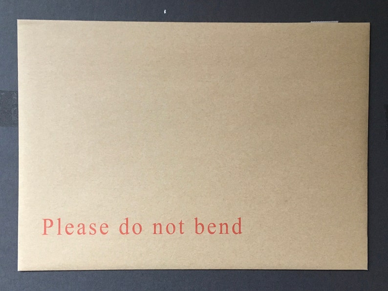 May include: A brown paper envelope with the text "Please do not bend" printed in red.