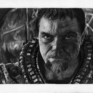 May include: A black and white pencil drawing of a man with a serious expression. He has short, dark hair and a beard. He is wearing a dark, textured garment.