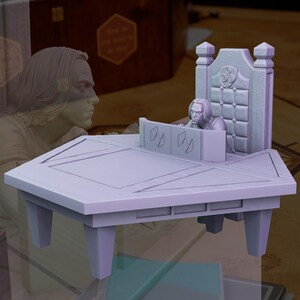 May include: A purple, hexagonal table with three legs. A miniature figure of a person sitting in a throne with a carved back is behind the table.
