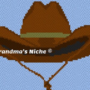 Könnte beinhalten: Ein brauner Cowboyhut mit einem braunen Band vor einem hellblauen Hintergrund. Der Hut hat eine breite Krempe und eine spitze Krone. Der Text "Grandma's Niche ©" ist auf dem Hut sichtbar.