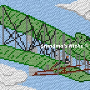 May include: A green and brown crochet pattern of a vintage airplane flying in a blue sky with white clouds. The text "Grandma's Niche" is in the center of the image.