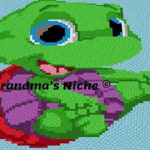 May include: A colorful, pixelated turtle design on a light blue background. The turtle features a green head and limbs, a red and purple shell, and large eyes. The text "Grandma's Niche" is visible.