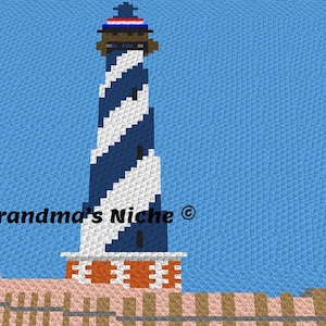 May include: A blue and white striped lighthouse with a red, white, and blue hat on top. The lighthouse is standing on a brown and pink platform. The text "Grandma's Niche ©" is visible below the lighthouse.