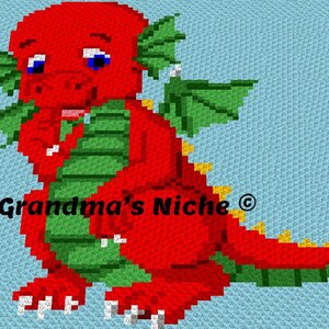 May include: A red and green pixelated dragon design on a light blue background. The dragon has blue eyes, green wings, and a yellow tail. The text "Grandma's Niche" is visible in black.