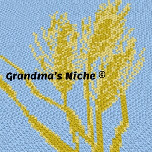 May include: A crochet pattern featuring a stylized image of wheat stalks in shades of yellow and light brown against a light blue background. The text "Grandma's Niche ©" is visible in the center of the image.