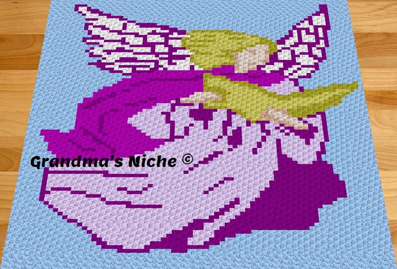 May include: A crochet pattern of an angel with purple and white wings, a purple dress, and blonde hair. The pattern is on a light blue background. The text "Grandma's Niche &copy;" is in the lower left corner.