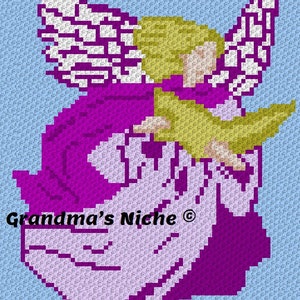 May include: A crocheted angel with purple and white clothing, holding a yellow bird in its arms. The angel has blonde hair and white wings. The background is light blue. The text "Grandma's Niche&reg;" is visible in the lower left corner of the image.
