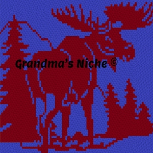 May include: A square textile piece featuring a pixelated dark red moose silhouette standing in a forest of pine trees against a bright blue background. The text Grandma's Niche is printed in black across the centre of the moose design.