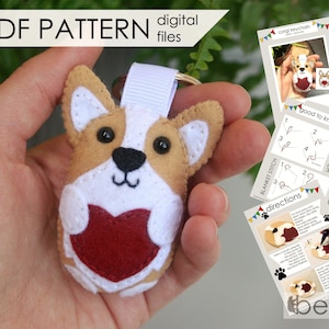 May include: A felt corgi keychain with a red heart on its chest. The keychain is held in a hand. The image also includes instructions for making the keychain, including a blanket stitch and back stitch.