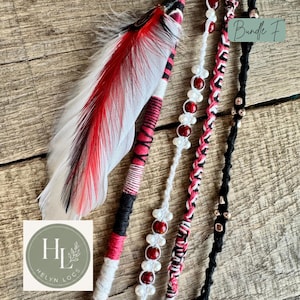 May include: A set of four hair accessories labeled Bundle F, featuring a long white feather with red and black tips, a wrapped cord in red, black, and white, a white cord with red and white beads, and a braided cord with black and red accents.