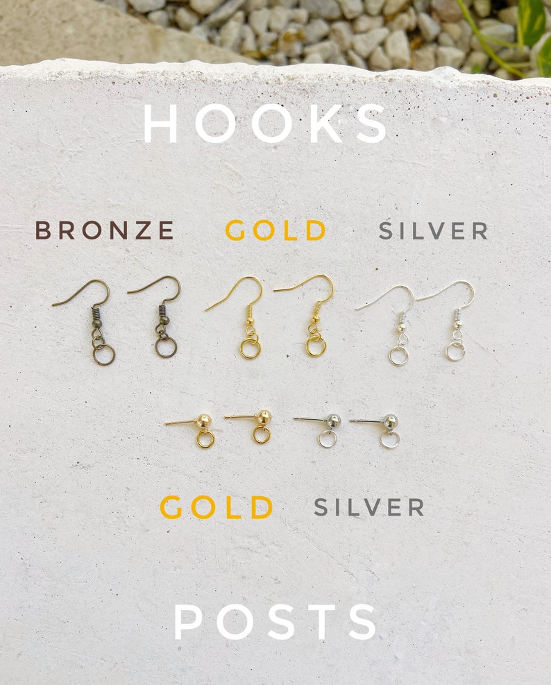 May include: A selection of earring hooks and posts in bronze, gold, and silver. The hooks are shown in three rows, with bronze on top, gold in the middle, and silver on the bottom. The posts are shown in two rows, with gold on top and silver on the bottom. The text "HOOKS" is at the top of the image, and the text "POSTS" is at the bottom.