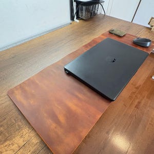 Rustic brown full grain leather desk mat, wide desktop view shows laptop, mouse, and rollable sturdy desk mat use