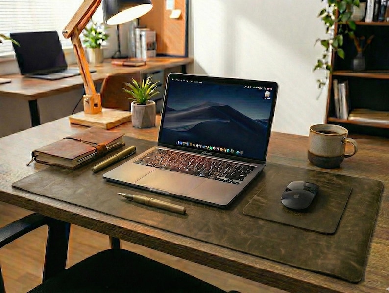 Warm studio angle, olive green crazy horse finish full grain leather desk mat under laptop, mouse, wooden desk