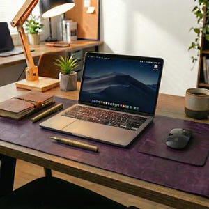 Plum purple full grain leather desk mat with vintage grain, laptop, mouse and desk lamp accent
