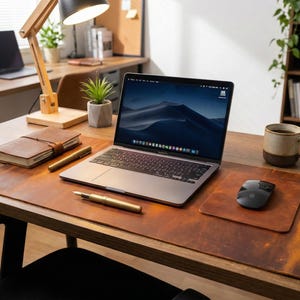 Tan cognac full grain leather desk mat, rich patina crazy horse leather, laptop and pen at center